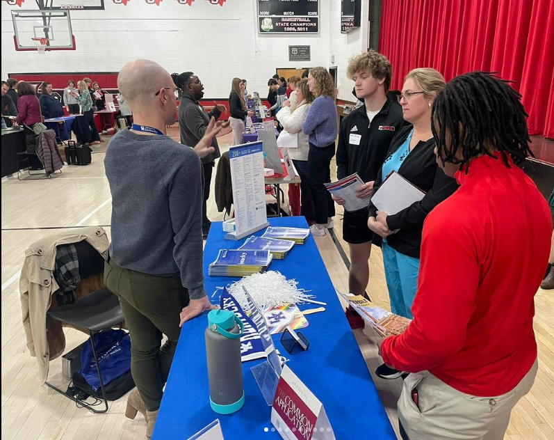 Students talking to college representative